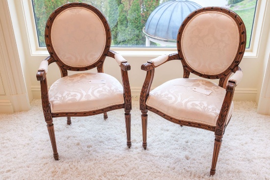 Pair (2) of Louis XVI mahogany arm chairs covered in ivory damask,  Approx.