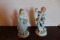 Pair Of Fine Porcelain Figurines, Boy And Girl Sitting On Stumps Holding Fl