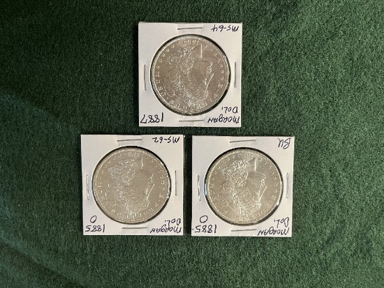 (3) Morgan Dollars: (1) 1885 Mint Mark O BU, (1) 1885 Mint Mark O MS-62 (1)