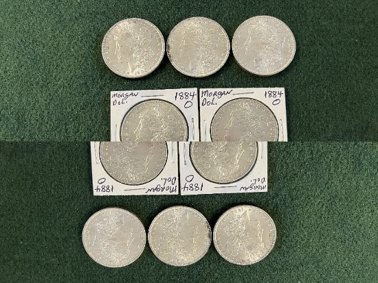 (7) Morgan Silver Dollars: (1) 1884 Mint Mark O BU, (1) 1884 Mint Mark O Un