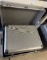 (4) Pieces of Luggage - 2 Metal Shipping Boxes with Hinges and 2 Rolling Su
