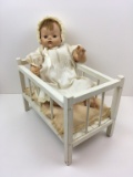 BABY DOLL IN WHITE CRIB WITH PILLOW