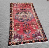 HANDMADE RUG WITH REDS ORANGES AND BLUES