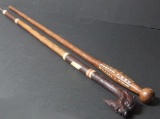 TWO CARVED WOOD CANES OR WALKING STICKS