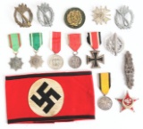 LOT OF 14: MISCELLANEOUS GERMAN WORLD WAR II MEDALS, COMBAT BADGES, AND SS ARMBAND.
