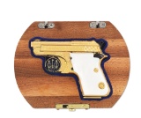 (M) FACTORY CASED, GOLD PLATED, AND ENGRAVED BERETTA MODEL 950BS SEMI AUTOMATIC PISTOL.