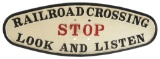 OVAL POLE-MOUNTED CAST IRON RAILROAD CROSSING SIGN.