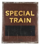 SPECIAL TRAIN ANNOUNCEMENT MASONITE SIGN W/ METAL BANDED FRAME.