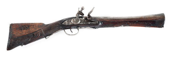 (A) HIGHLY DECORATED OTTOMAN FLINTLOCK KNEE GUN, WITH EXTENSIVE CARVING AND SILVER WIRE INLAY.
