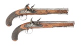 (A) A LATE PAIR OF MUSKET BORE FLINTLOCK PISTOLS BY JOHN HARCOURT