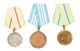 LOT OF 3: SOVIET NAKHIMOV MEDAL, PARTISAN 1ST CLASS, AND PARTISAN 2ND CLASS MEDALS.