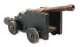 CAST IRON CANNON ON NAVAL CARRIAGE.