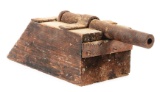 SMALL HOMEMADE TOY IRON CANNON ON WOOD BASE.