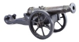 SMALL CAST BRONZE CANNON MODEL ON WOOD CARRIAGE.