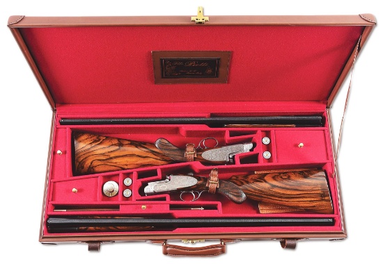 (M) A TRUE PAIR OF PIOTTI BEST QUALITY SLE 12 GAUGE OVER/UNDER SHOTGUNS WITH SCROLLWORK AND GAME SCE