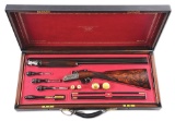 (M) DAVID MCKAY BROWN ROUND ACTION GAME GUN WITH FRENCH FITTED CASE AND ACCESSORIES.