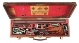 (A) AN ATTRACTIVE AND WELL ACCESSORIZED STEPHEN GRANT & SONS 450 SIDELEVER DOUBLE RIFLE WITH CASE.