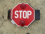 Swinging arm stop sign