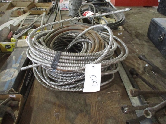 large spool of metal wire loom and copper tubing