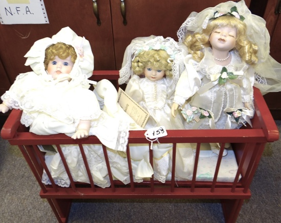 RED BABY CRIB & 3 BABY DOLLS