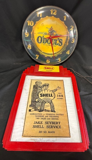 1303 - SHELL FRAMED NEWSPAPER CLIPPING - BROKEN & O'DOUL'S LIGHTED CLOCK