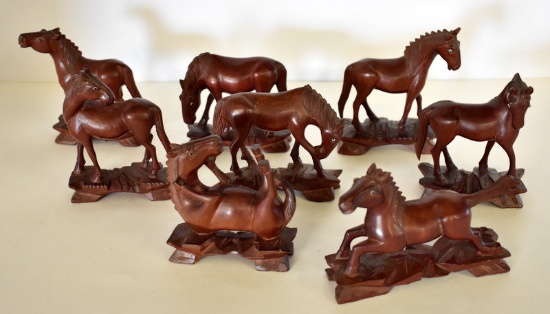 EIGHT HAND-CARVED WOODEN HORSES