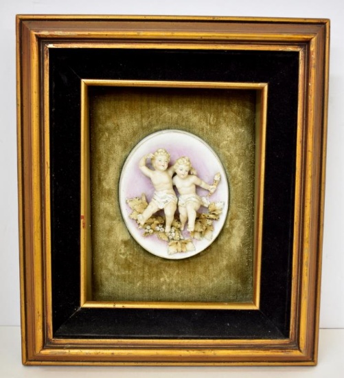 TWO FRAMED PUTTI IN RELIEF