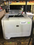 HP LaserJet P2055dn Printer and Silver Metal Trash Can
