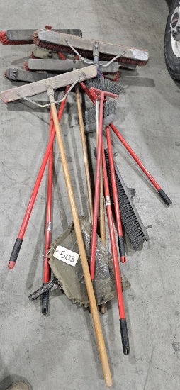 Assortment of brooms and dust pans