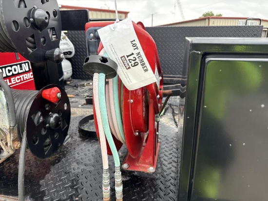 Hose reel includes oxygen acetylene hoses.