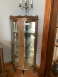 Lighted corner oak curved cabinet w/ glass shelves