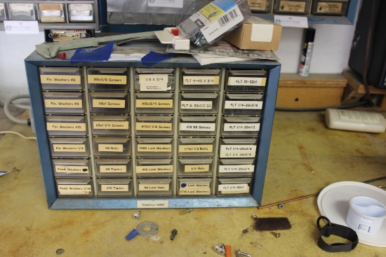 Organizer with misc. machine screws and several drawers empty. Buyer to remove from wall.