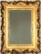 A 19TH CENTURY MIRROR WITH HEAVY ROCOCO FRAME