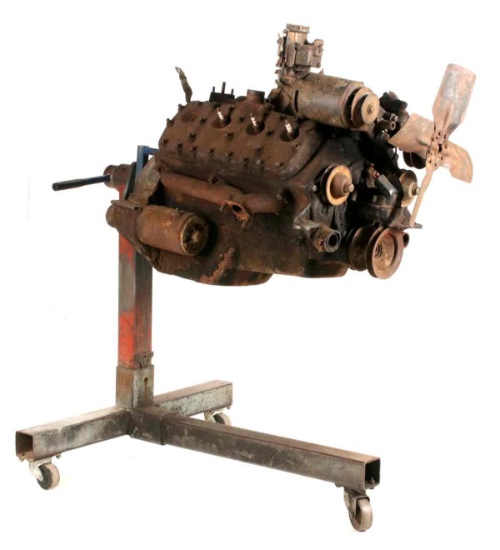 A VINTAGE FLAT HEAD FORD V-8 ENGINE ON STAND