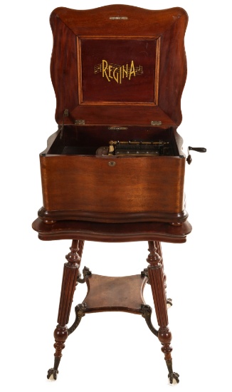 A REGINA MUSIC BOX ON CLOSELY MATCHED MAHOGANY STAND