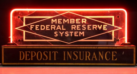 A FEDERAL RESERVE DEPOSIT INSURANCE SIGNED WITH RED NEON