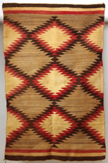 A NAVAJO GANADO TRANSITIONAL RUG WITH BANDED ENDS