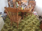 OAK PEDESTAL TABLE AND 6 CANE SEAT STYLE CHAIRS WITH PRESS BACK. EXTRA LEAF