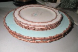 4 NESTING MUD PIE PLATES. ONE IS CHIPPED