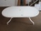 HEAVY PLASTIC WHITE UMBRELLA OBLONG TABLE. LEGS ARE SEPARATE AND CAN BE FOL