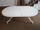 HEAVY PLASTIC WHITE UMBRELLA OBLONG TABLE. LEGS ARE SEPARATE AND CAN BE FOL