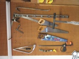 SAWS, LEVEL, AND ETC HANGING ON WALL