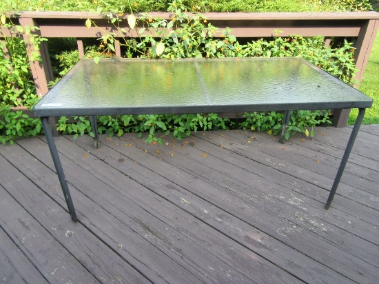 GLASS TOP PATIO TABLE. NO CHAIRS. APPROXIMATELY 5 FOOT BY 3 FOOT