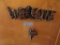 WELCOME WESTERN SIGN AND SMALL SADDLE