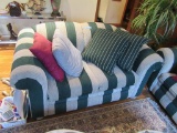 2 GREEN STRIPED LOVESEATS WITH PILLOWS