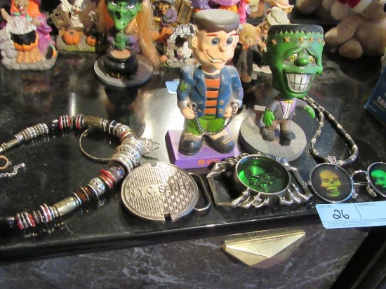HALLOWEEN BOBBLEHEADS, NECKLACE, SKULL GLASSES, AND NEW YORK SEWER BELT BUC