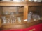 VARIETY OF GLASSWARE INCLUDING BUTTER DISH. CANDLESTICK HOLDERS. PITCHERS.