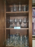 ASSORTED GLASSES AND STEMWARE IN CABINET