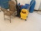 LOT MOP BUCKET, SWEEPER, FOLDING CHAIRS, BLUE PLASTIC ROLLABOUT CART, BLUE GARBAGE CAN, AND TWO-DRAW