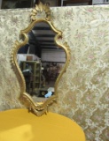GOLD-FRAMED WALL MIRROR. SMALL CHIP TAPED TO FRAME